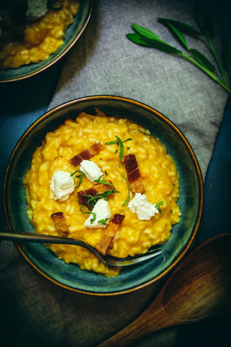 Butternut squash risotto in a blue bowl.