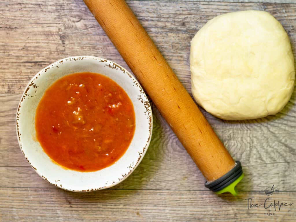pie dough with pie filling and rolling pin