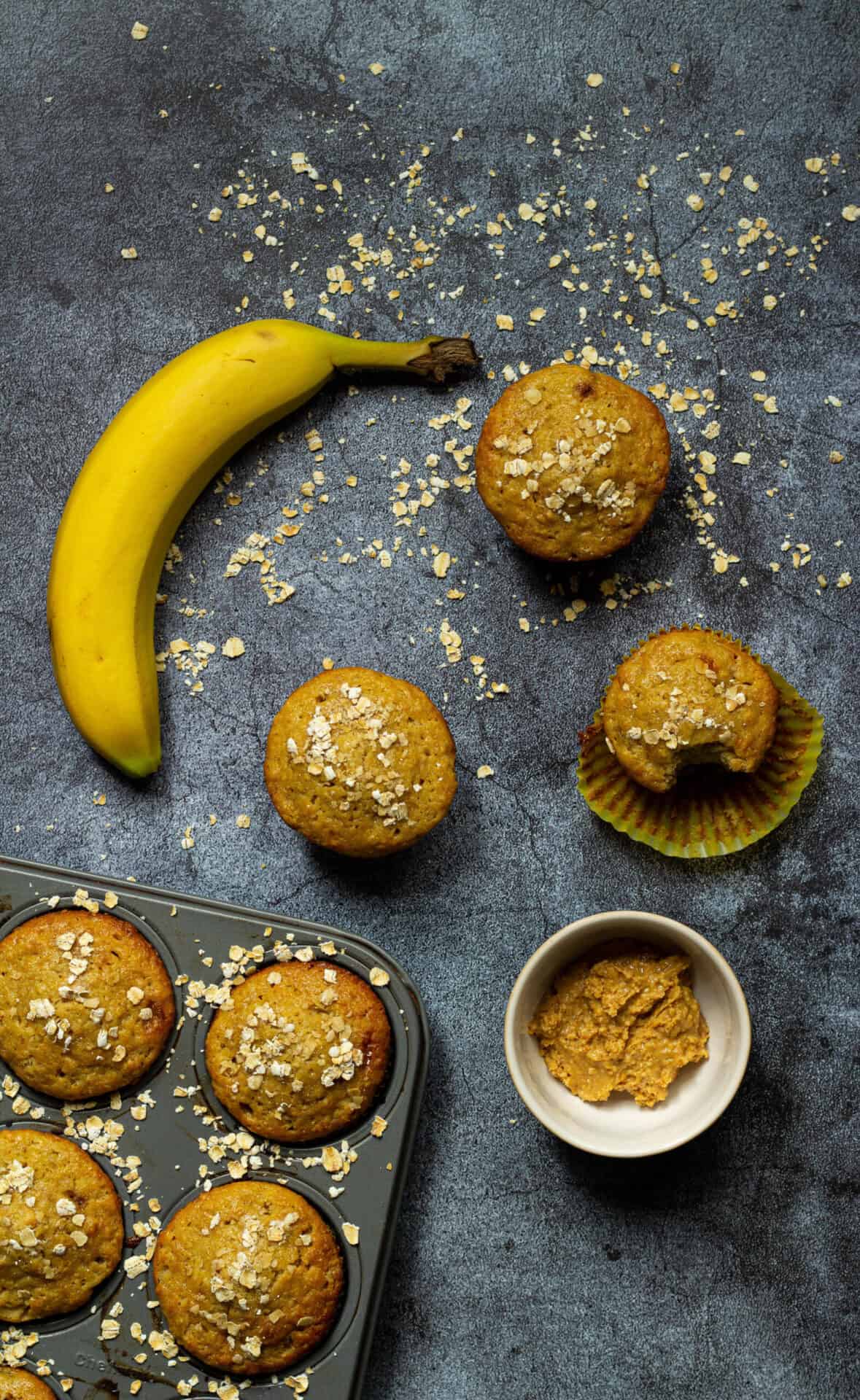 peanut butter banana oat muffins with a banana
