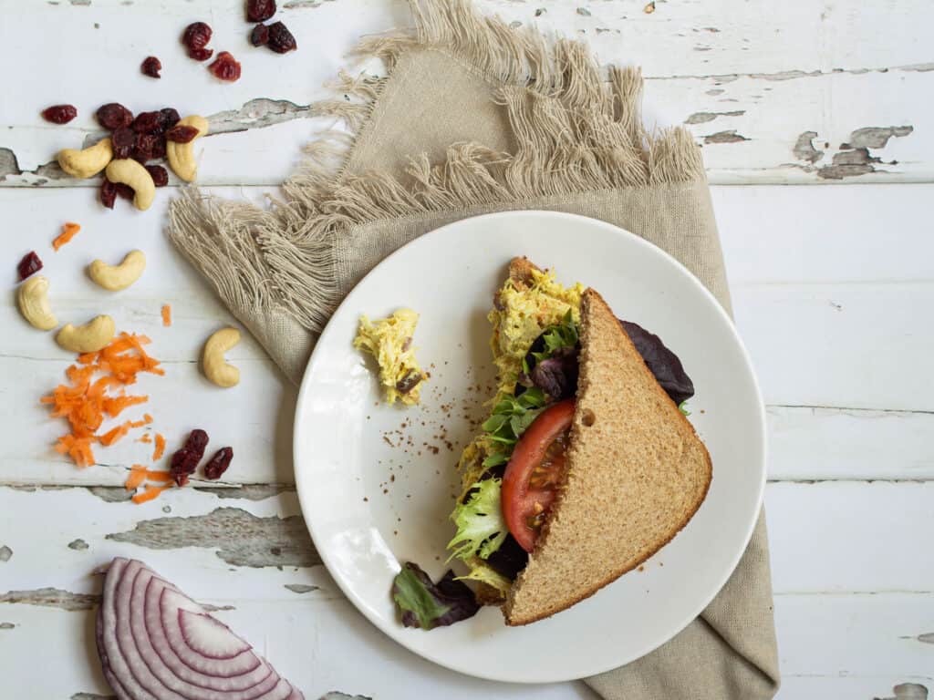 curried chicken salad sandwich on plate with napkin