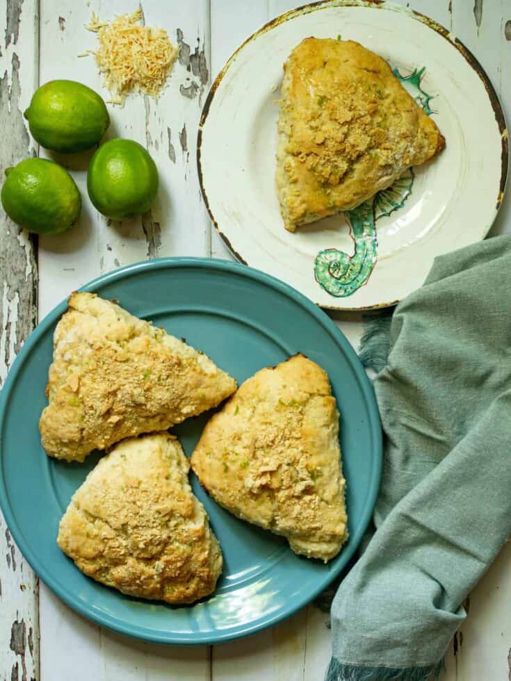 scones on a blue plate next to a white plate with a scone