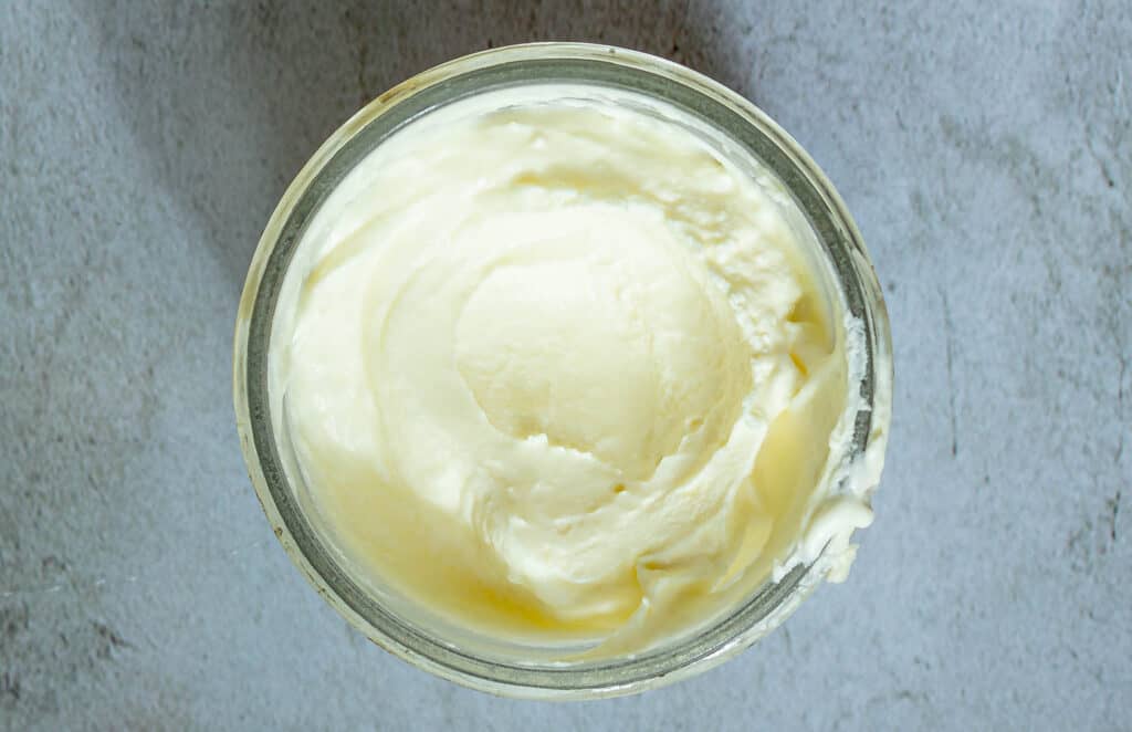 close up photo of creme fraiche in a jar