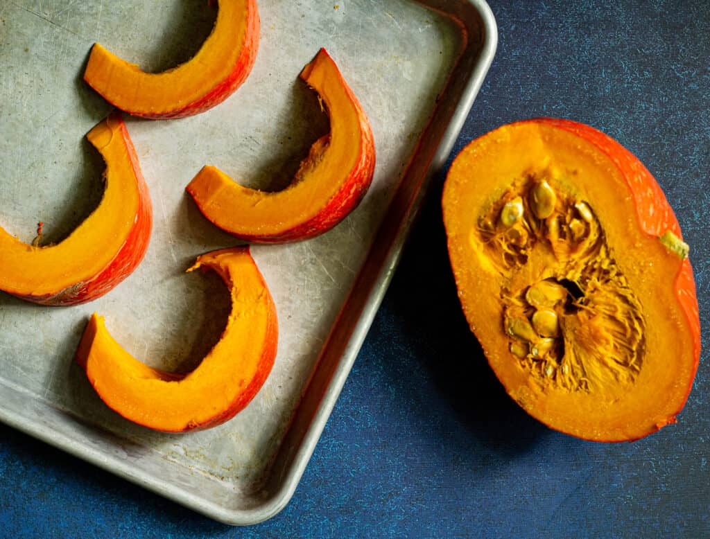 cut up red kuri squash on a sheet pan