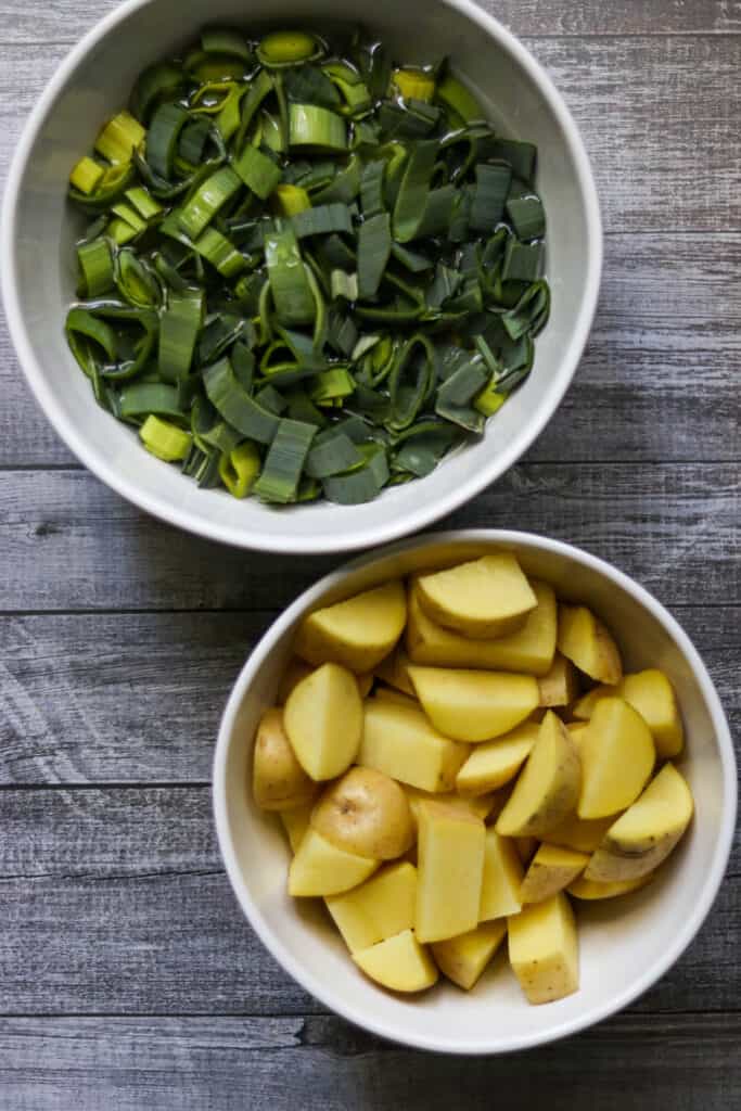chopped potatoes and sliced leeks in bowls