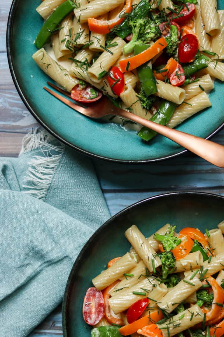 rigatoni primavera in bowls on a blue background