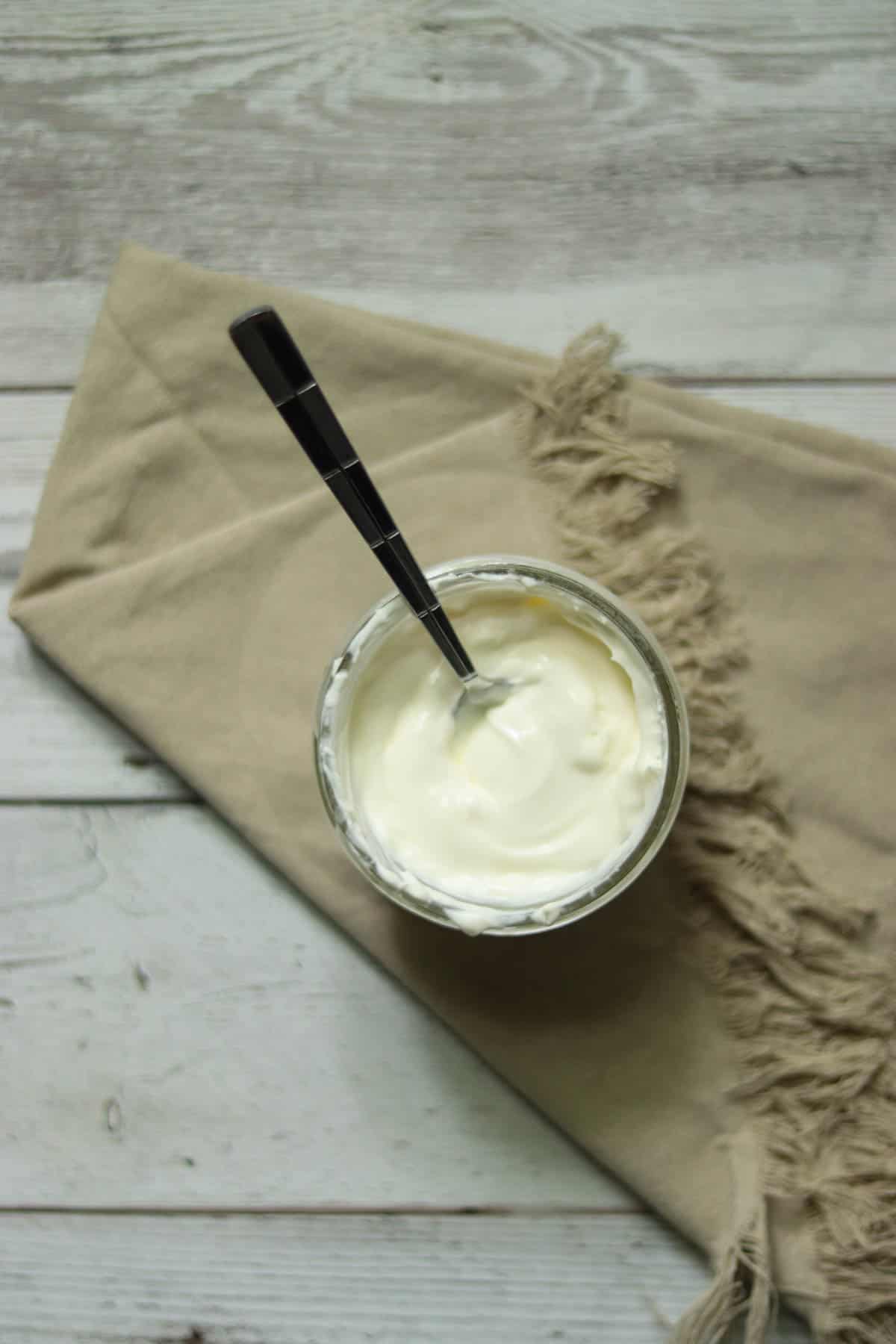 jar of creme fraiche with a spoon