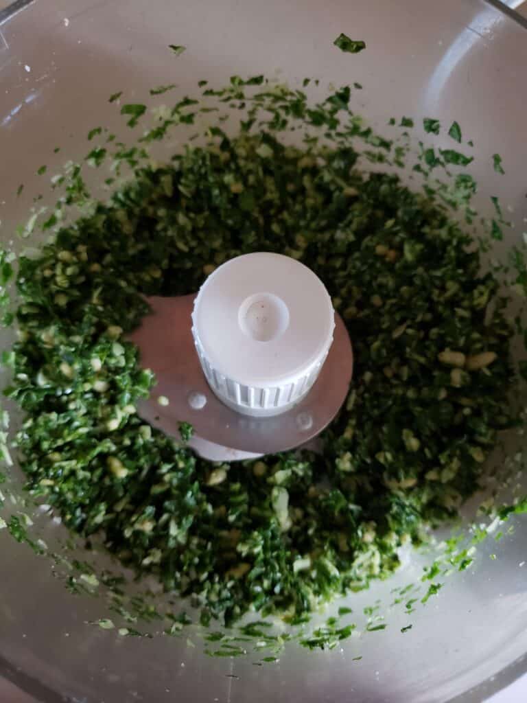 Processing the pesto in the food processor.