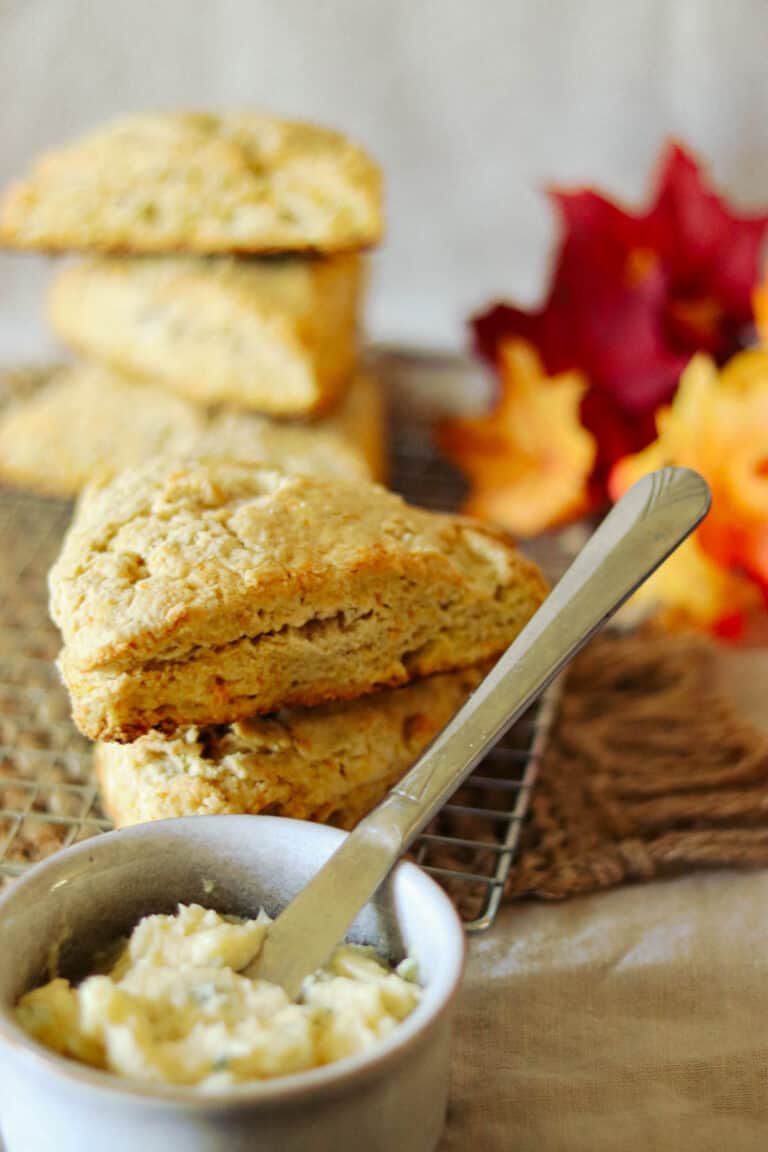 five pumpkin scones with maple thyme butter and a knife.