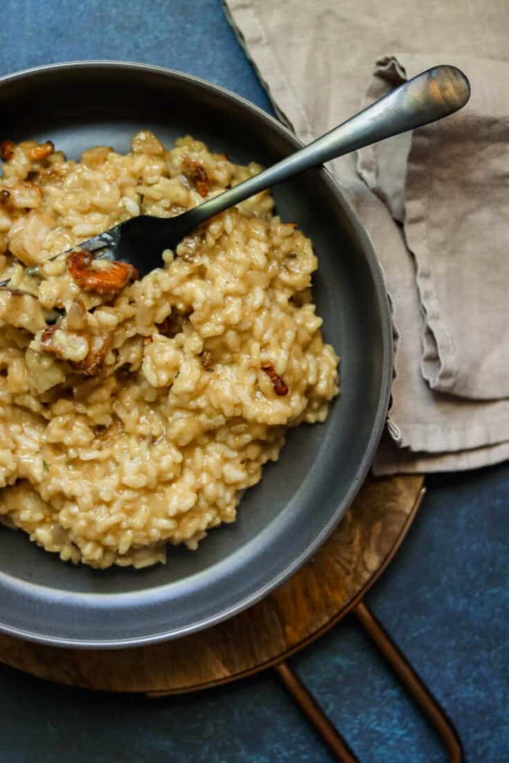 risotto in a bowl with a napkin and a fork.