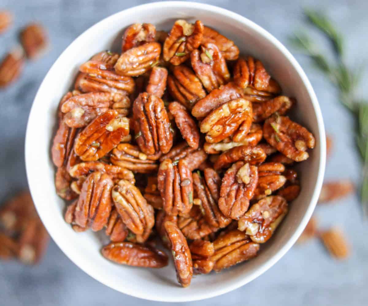 closeup of spicy candied pecans in a white bowl