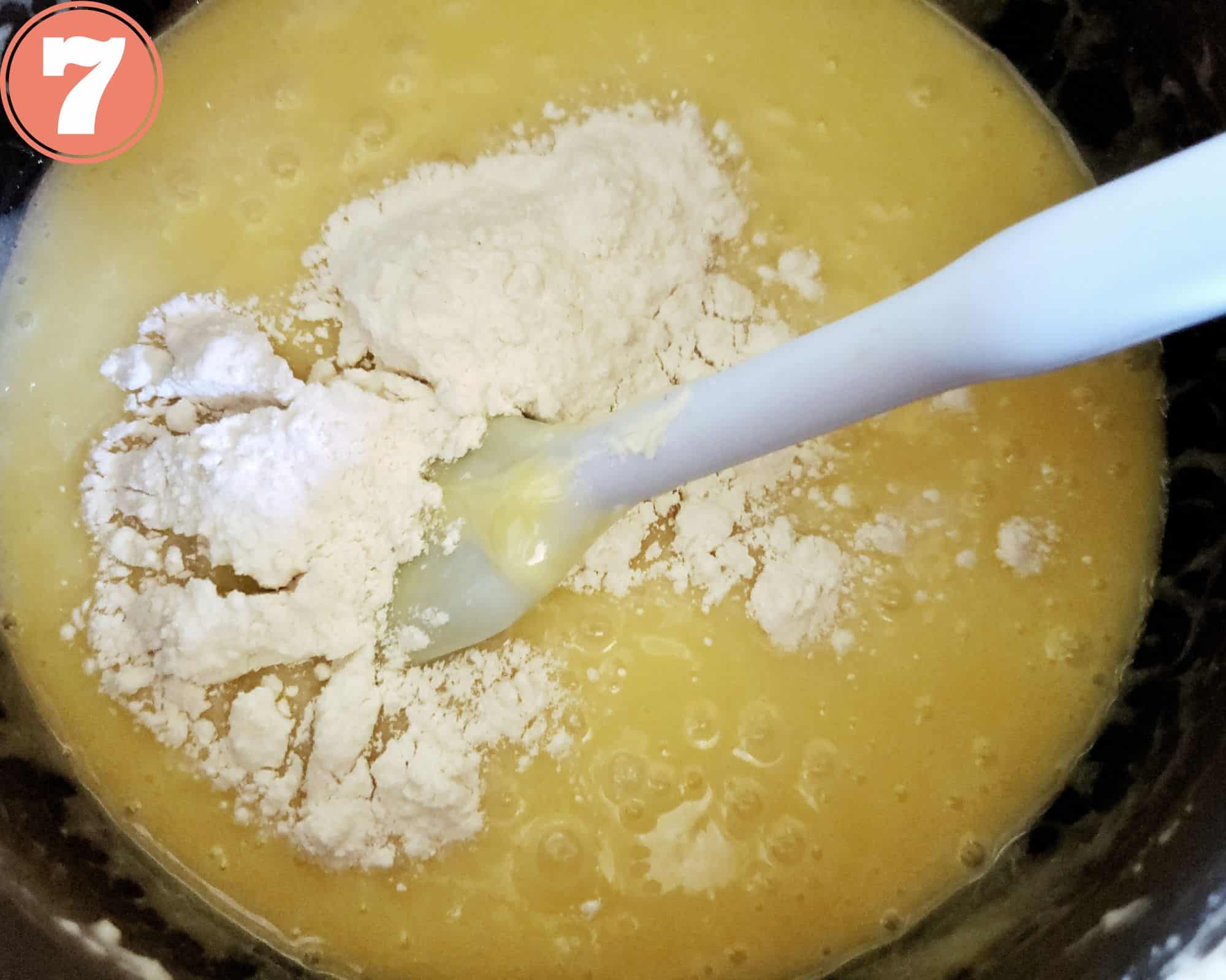 Adding flour to the blondie batter.