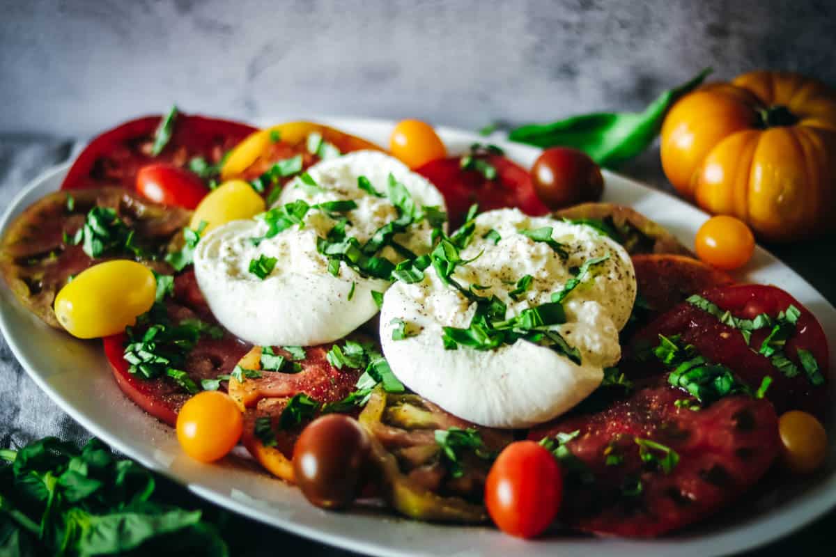 caprese salad on a large white plate.