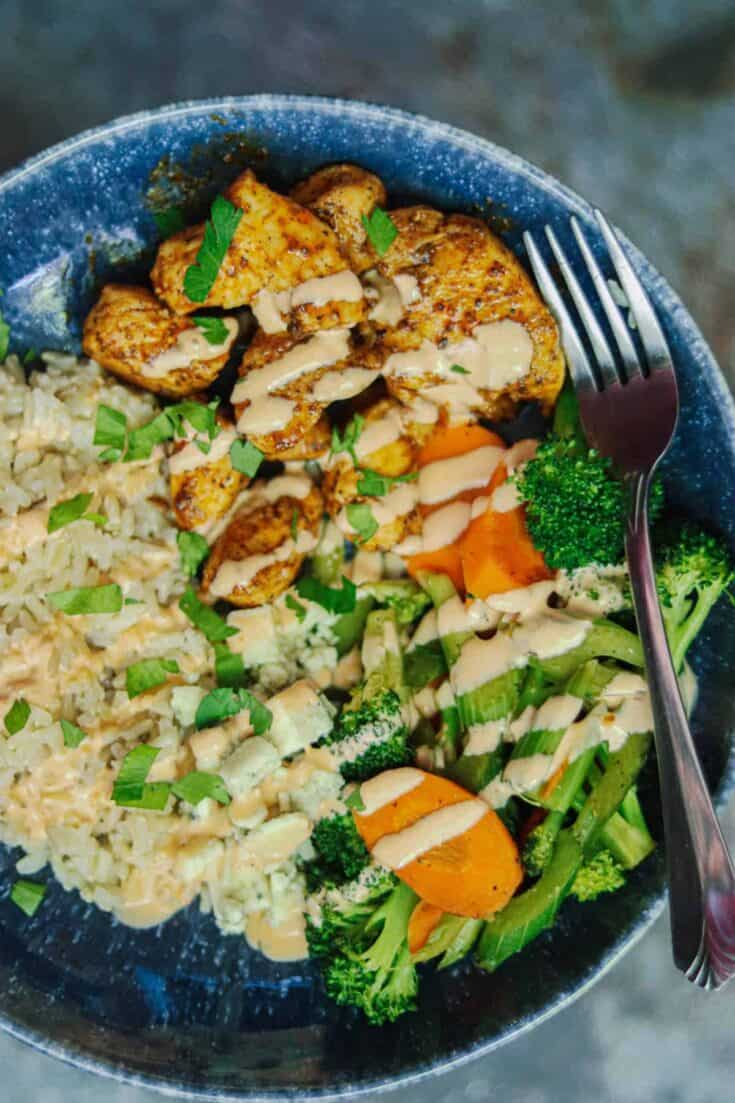 Closeup photo of a Buffalo Chicken Rice Bowl with a fork.
