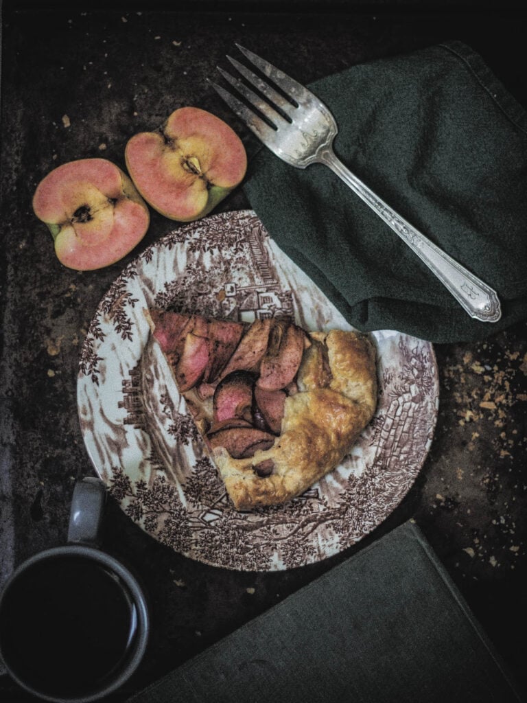 Slice of a galette on a plate with a fork.