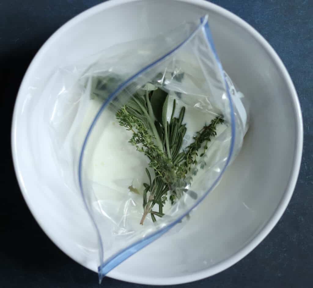 Brine and herbs added to the bag.
