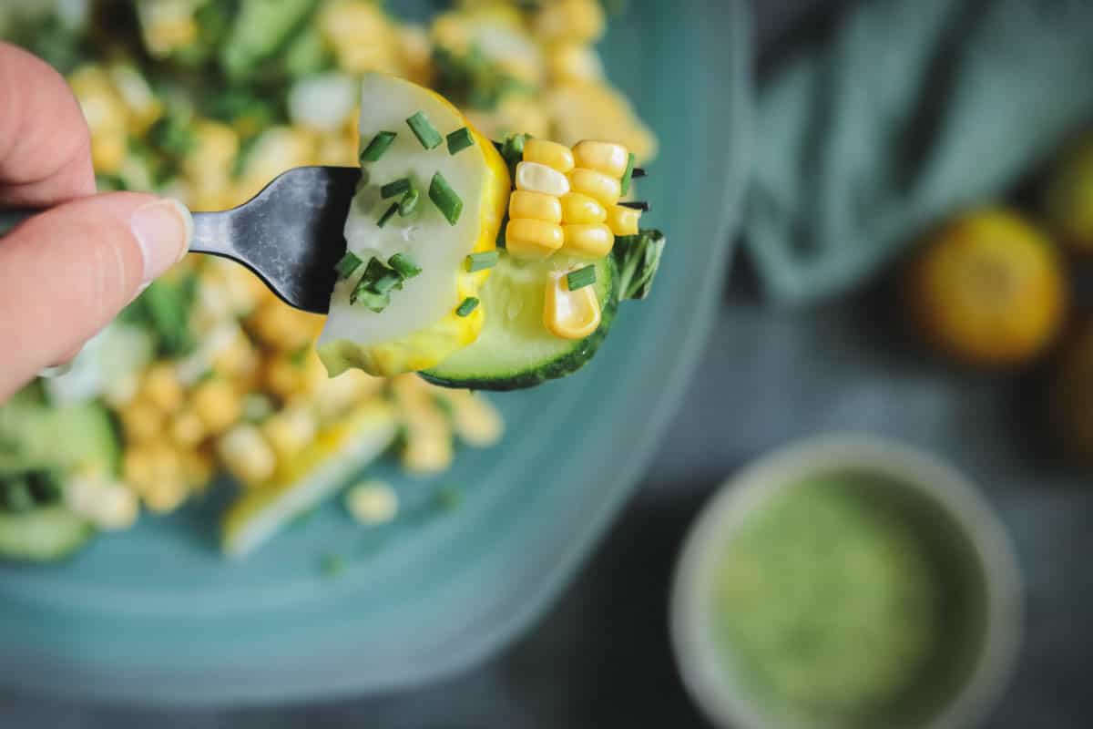 Lemon cucumber salad on a fork.