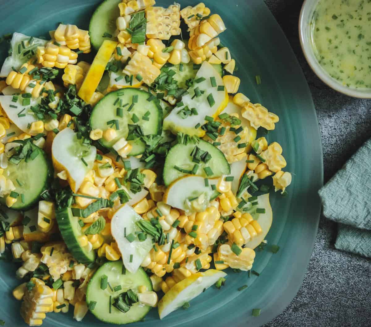 Closeup photo of lemon cucumber salad on a blue plate.