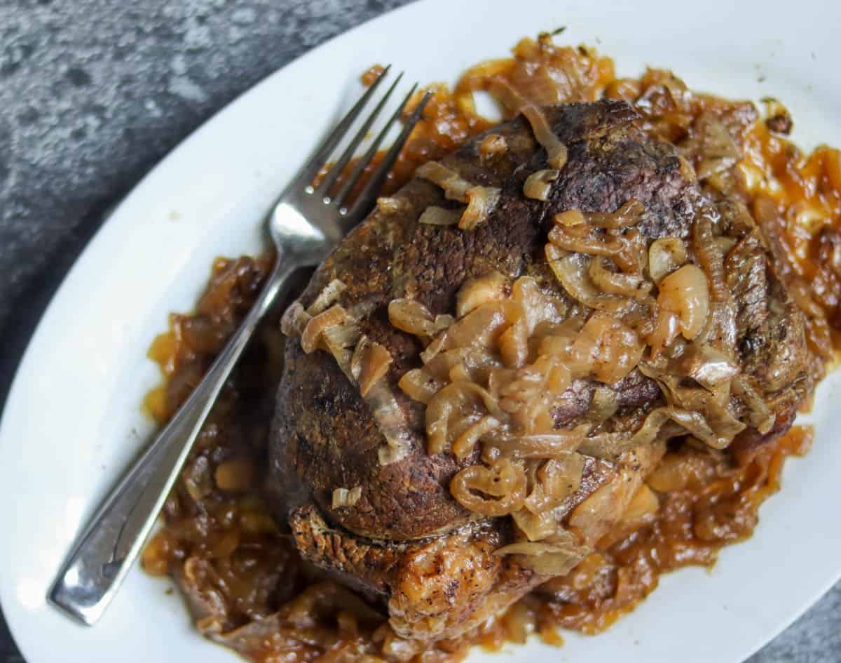 Beer braised roast on a plate with a fork.