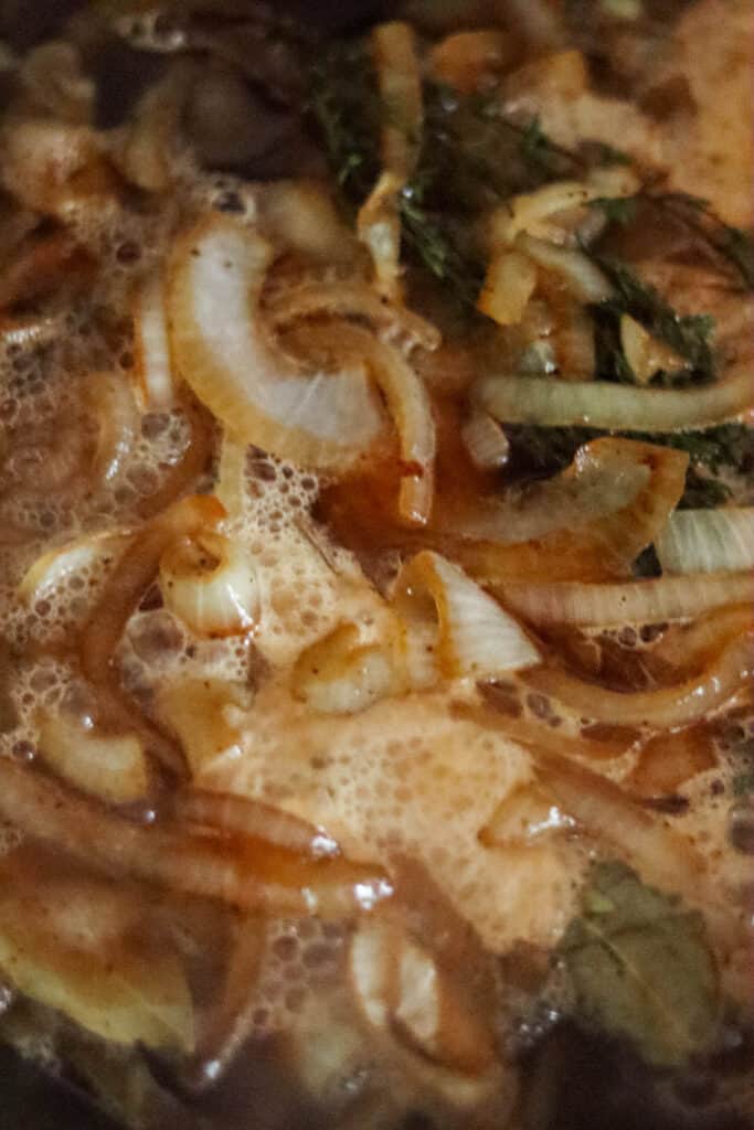 Beer added to the skillet with the onions.