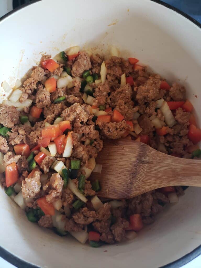 Add the chopped vegetables to the chorizo.
