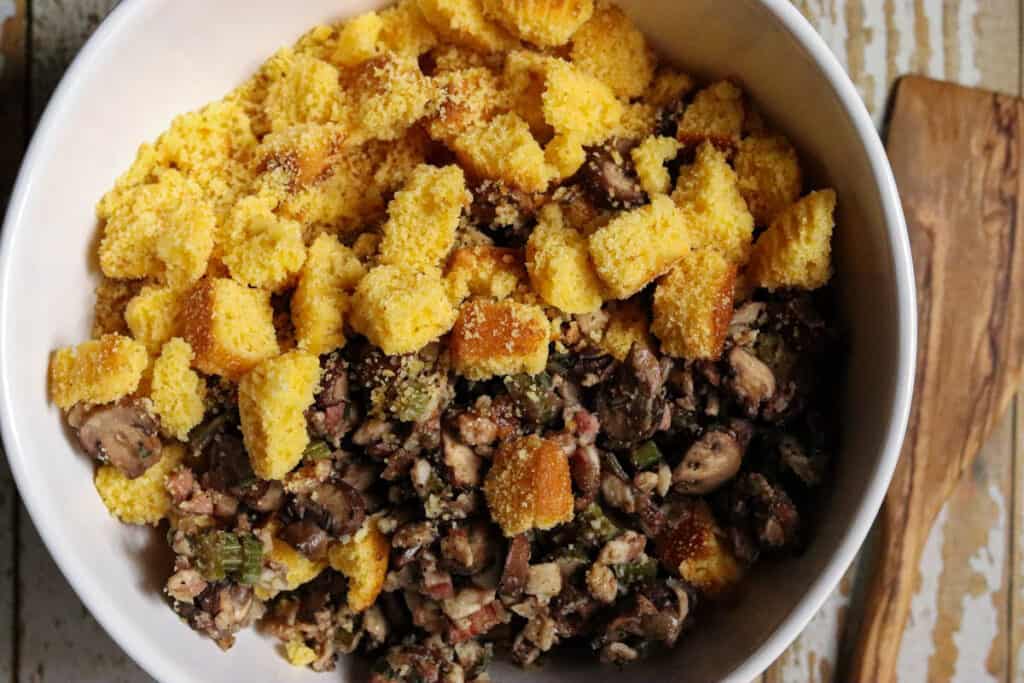 Large bowl of cornbread cubes and vegetables.
