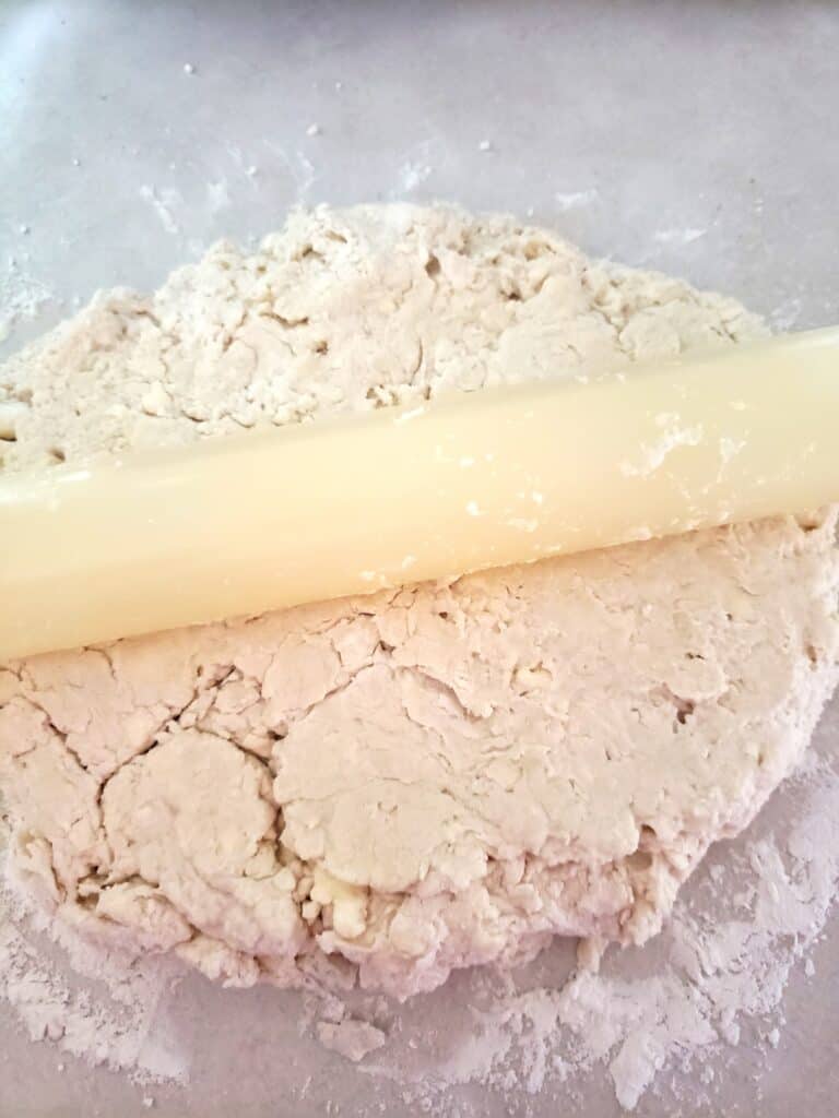 Rolling out the biscuit dough.