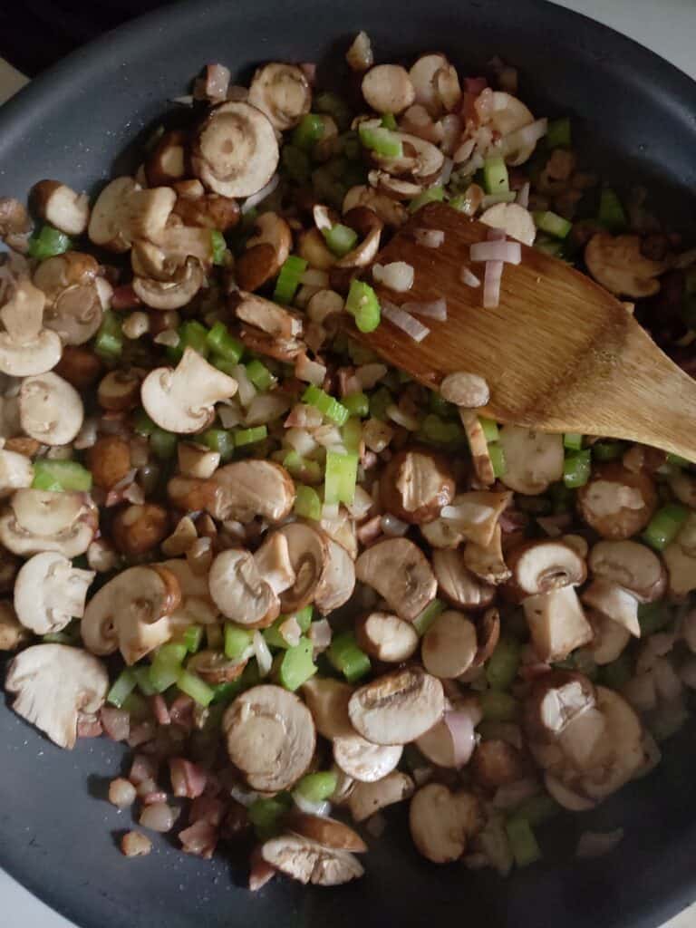 Vegetables cooking in a skillet.