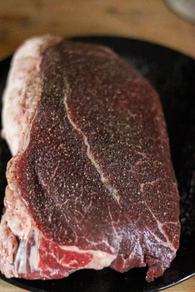 Cross rib roast seasoned with salt and pepper.