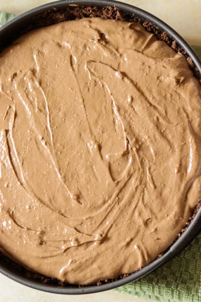 Cheesecake filling in a springform pan before baking.