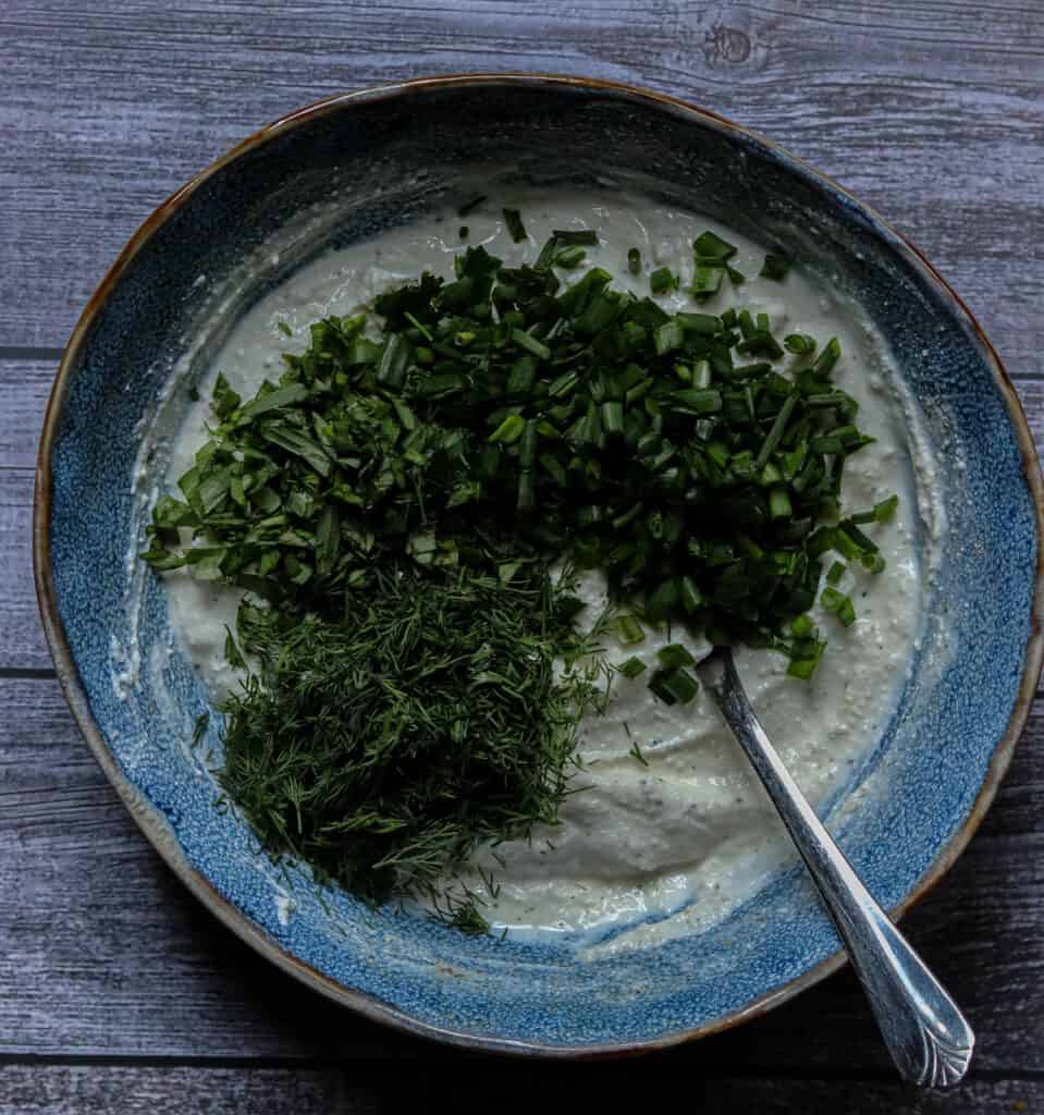 Herbs added to the dip base.