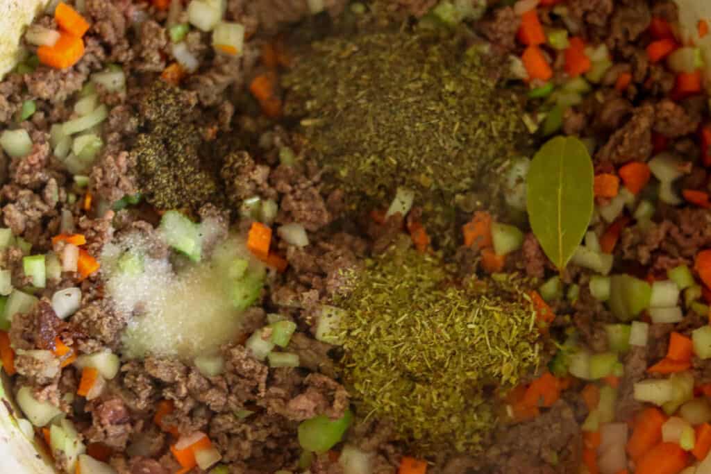 Seasonings being added to the sauce.