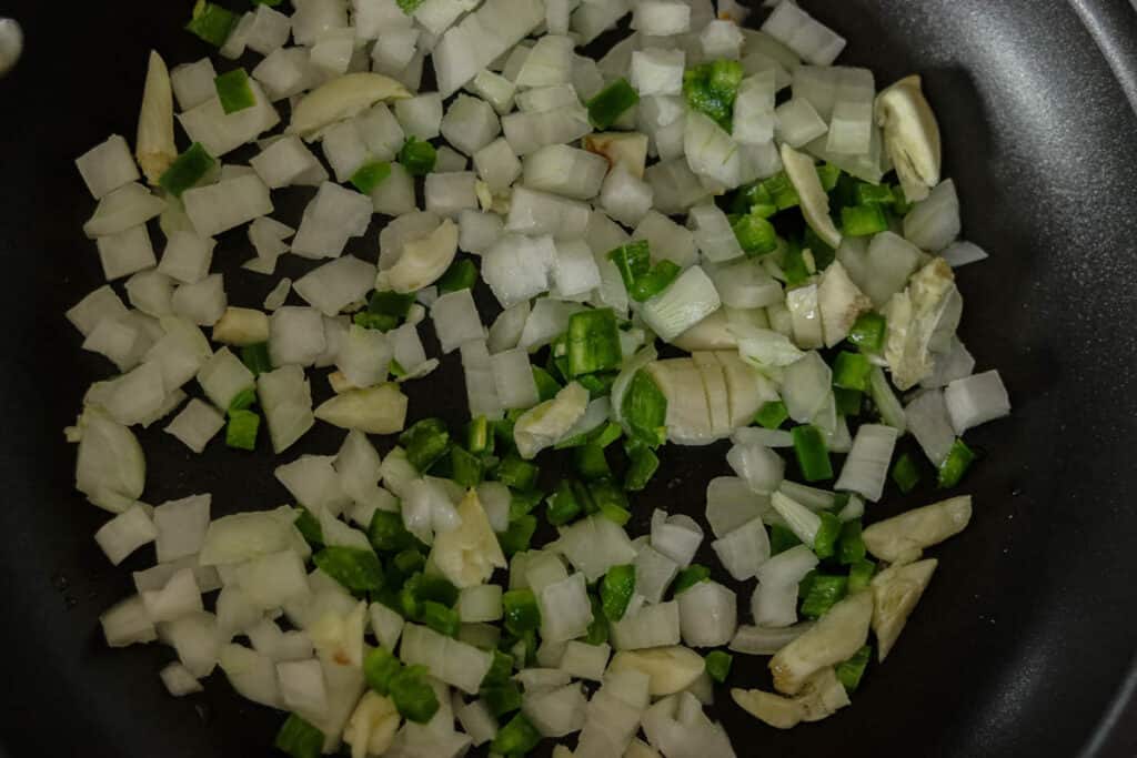 Onion, jalapeno, and garlic in a skillet.