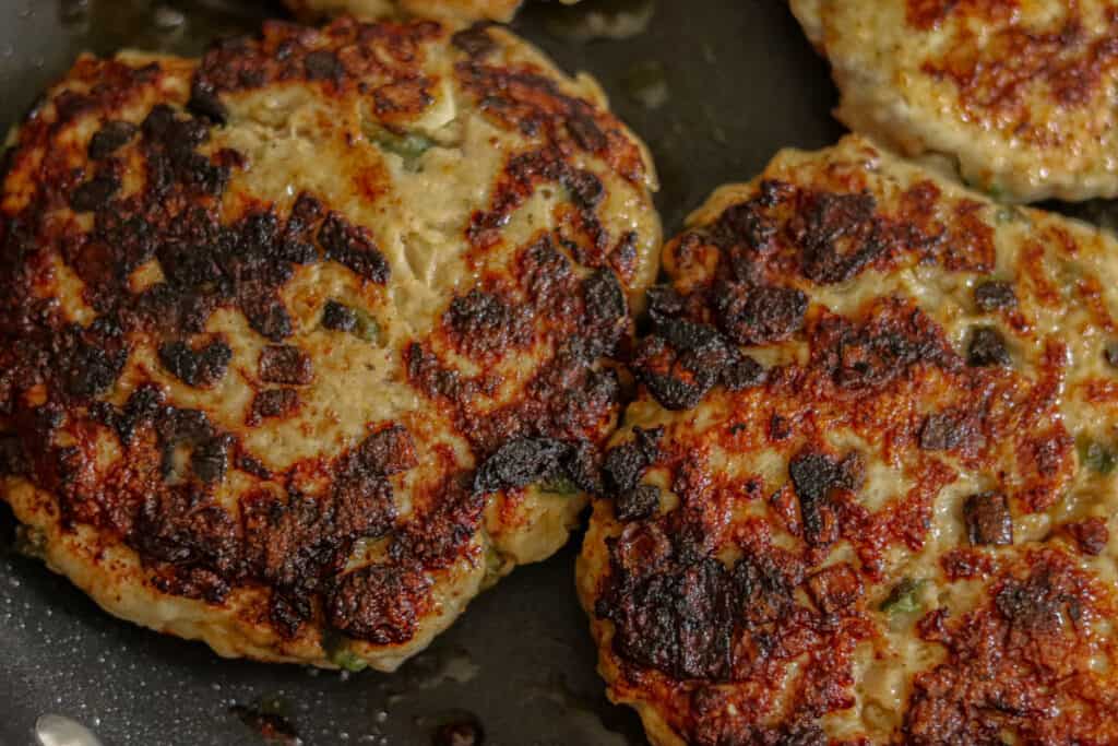 Cooked chicken burger patties.