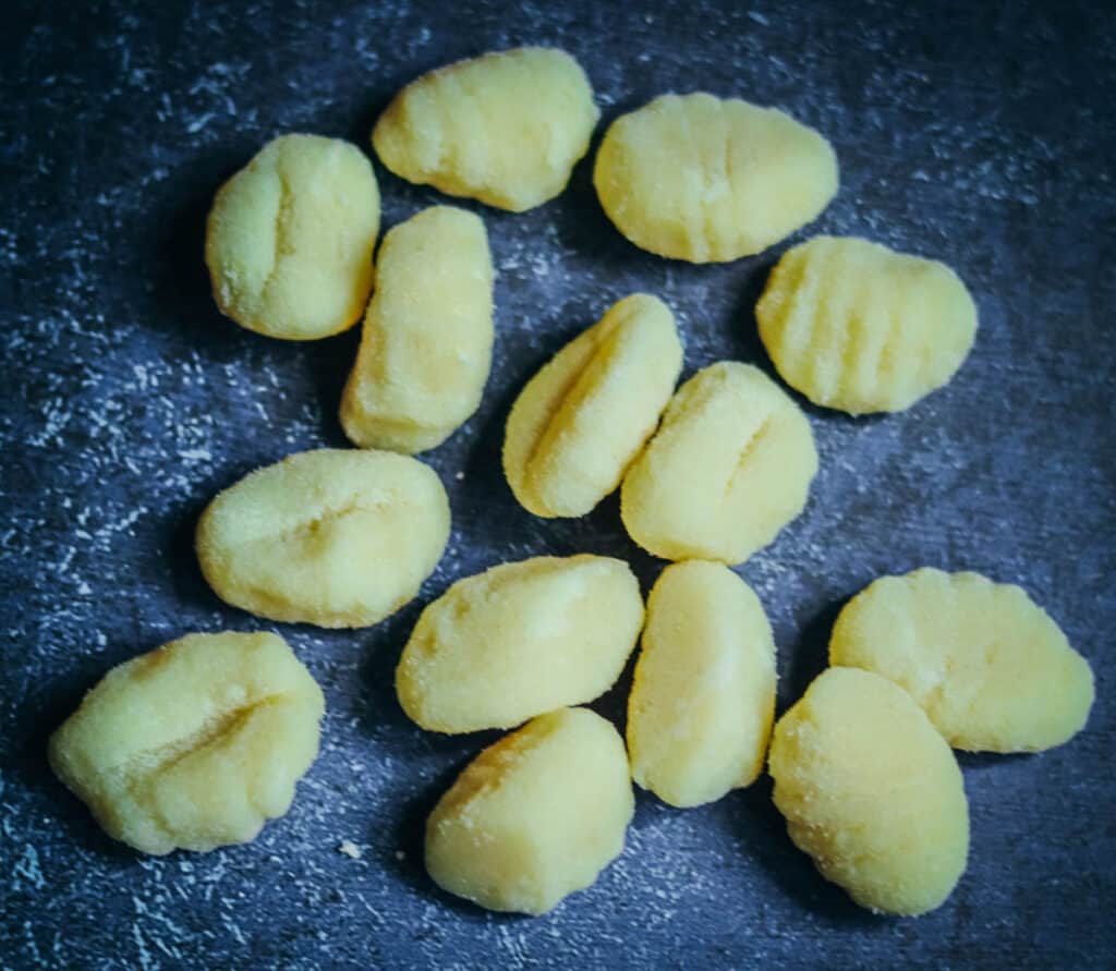 Close up photo of gnocchi on a blue background