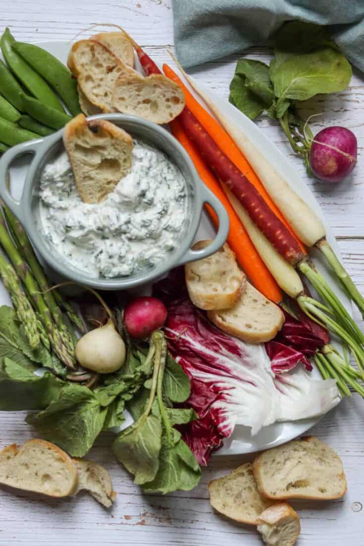 Spring crudite platter on a white plate.
