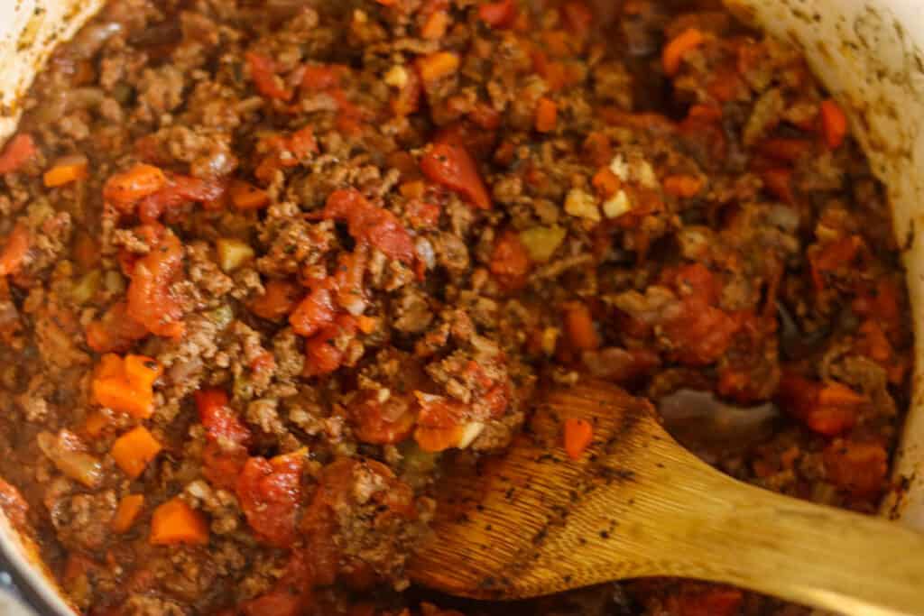 Photo of the tomatoes being stirred in.