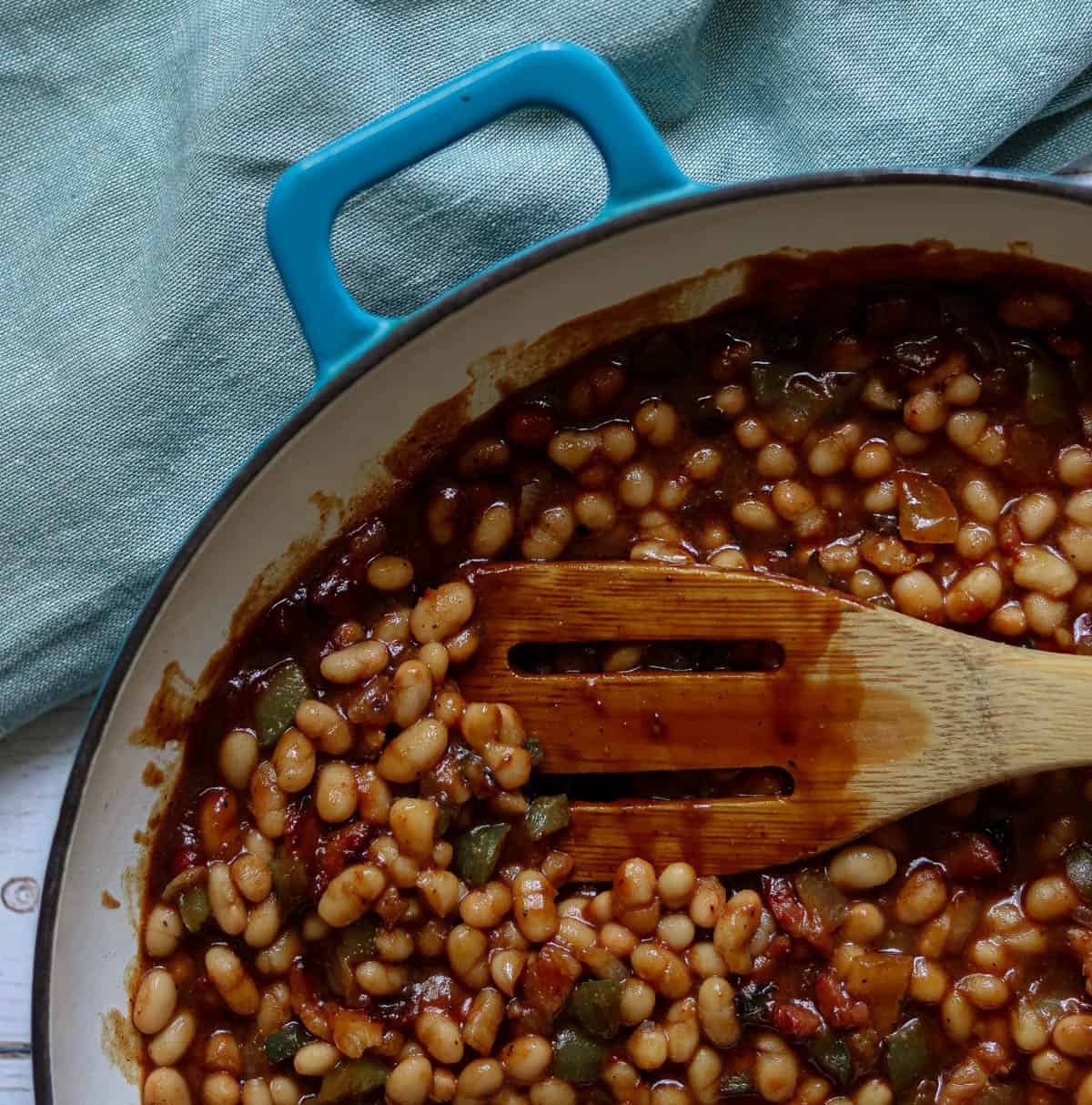 Baked beans in a blue pan.