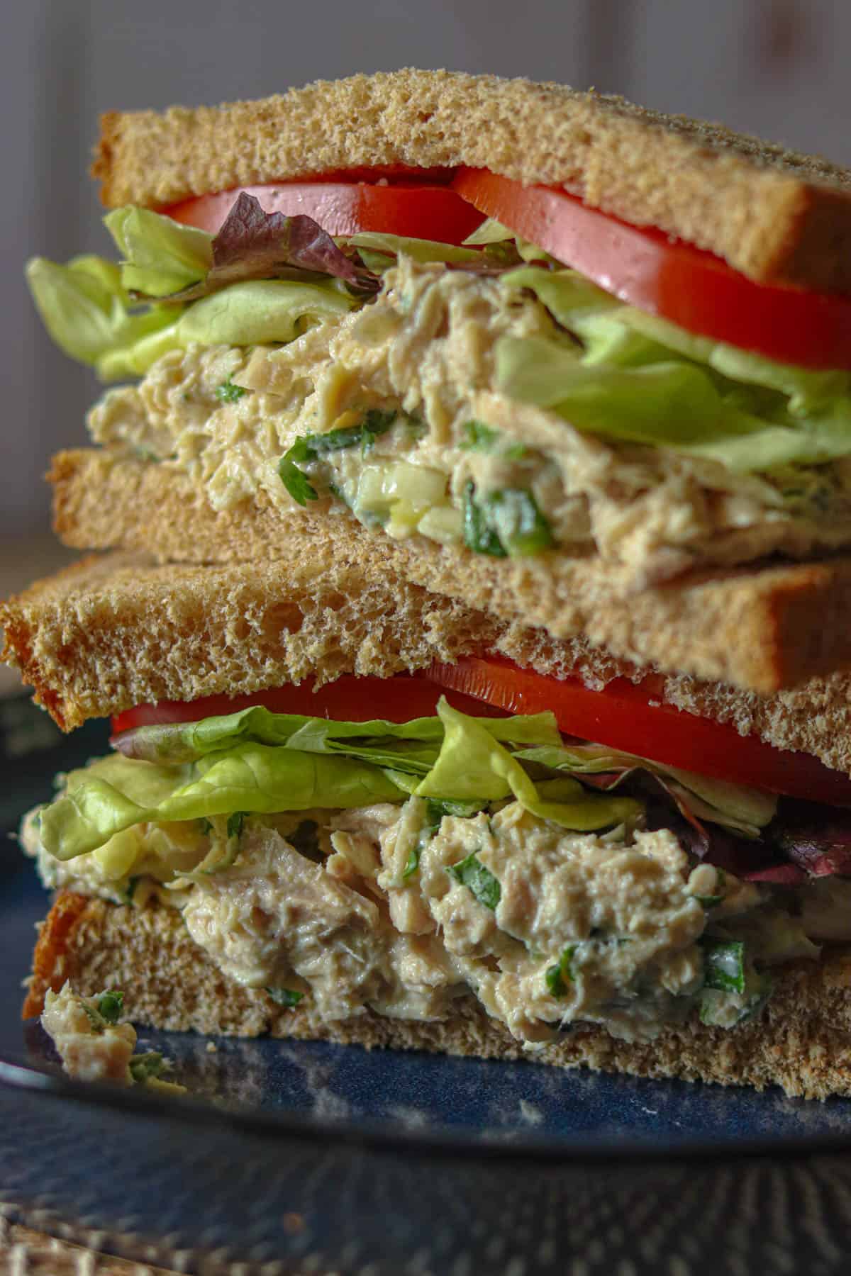 Spicy tuna salad sandwich with lettuce and tomato.