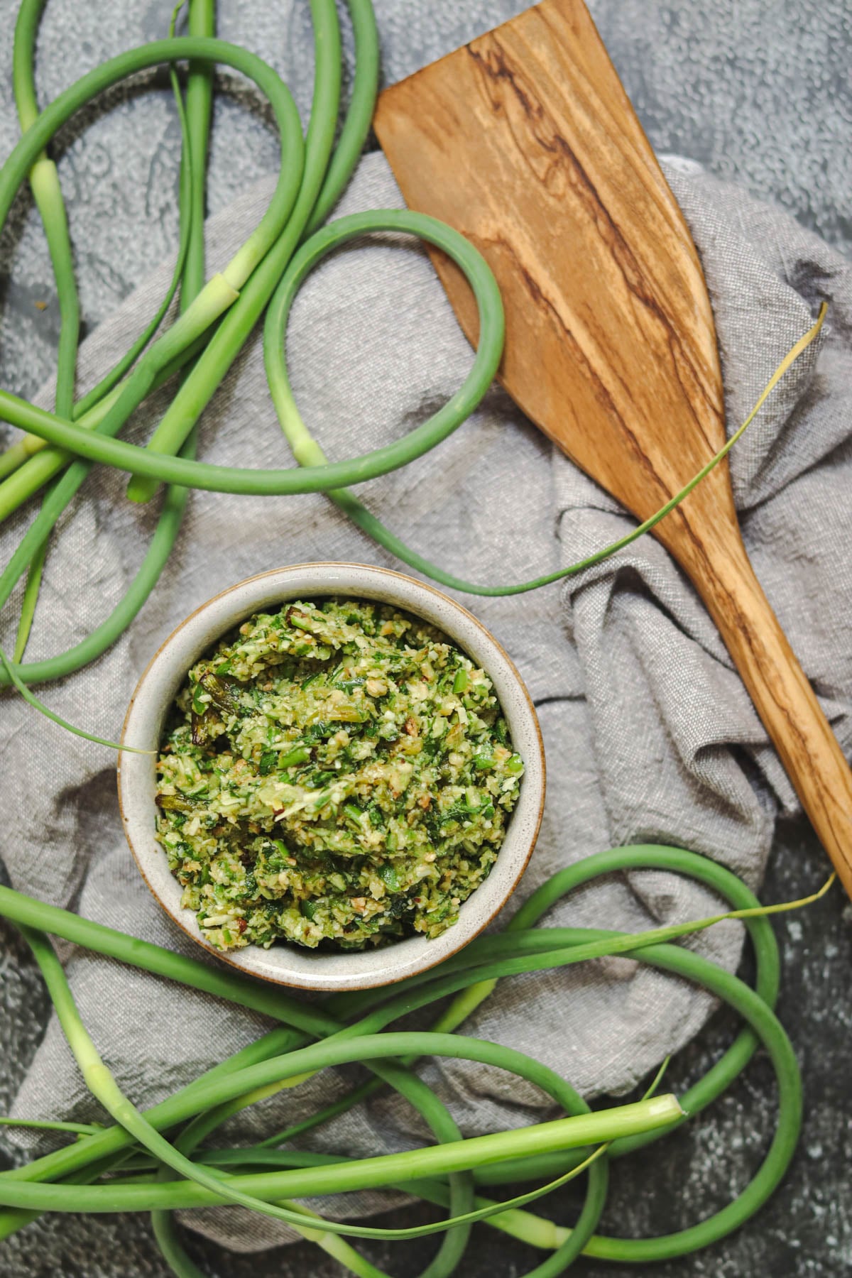 Garlic scape pesto with a wooden spoon.