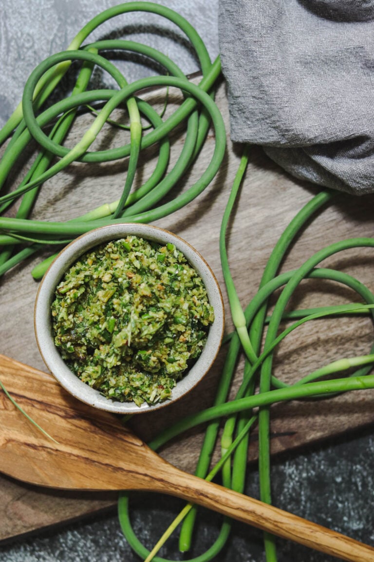 Pesto made with garlic scapes in a gray dish.