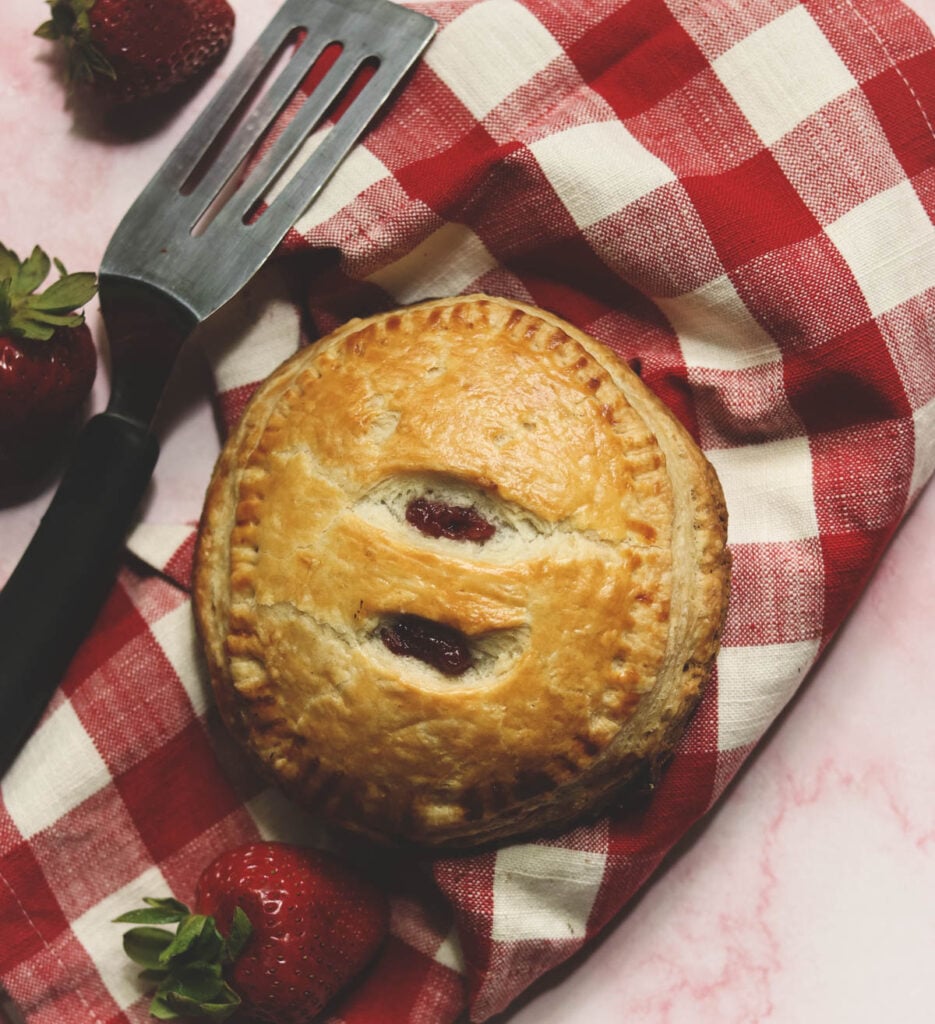 hand pie with a red and white checked napkin.