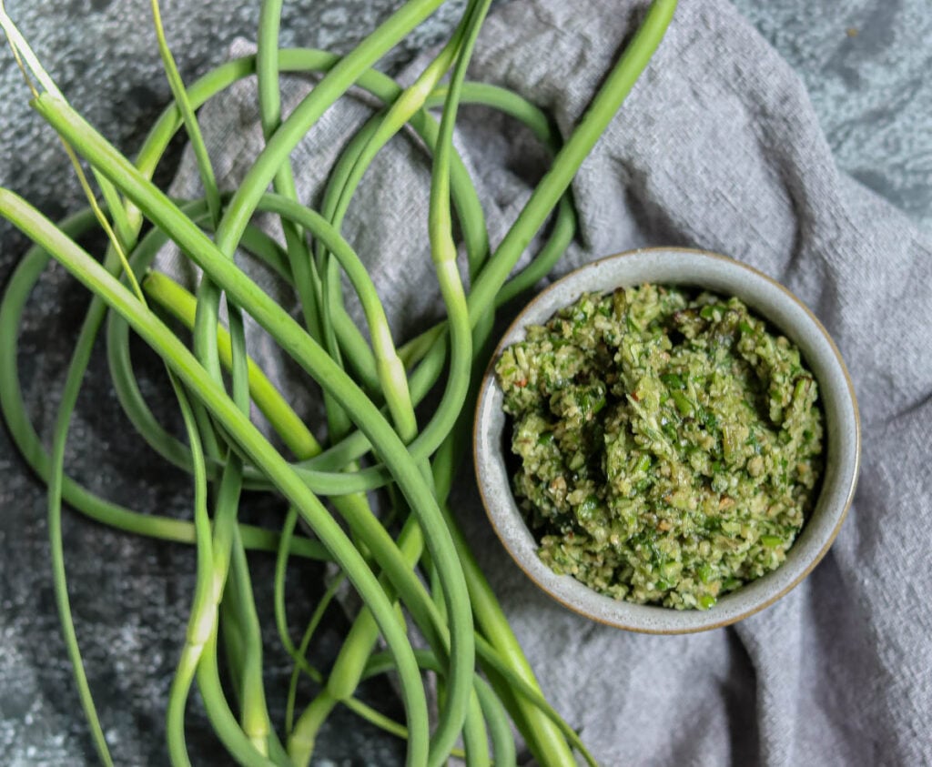 Bowl of pesto and garlic scapes.