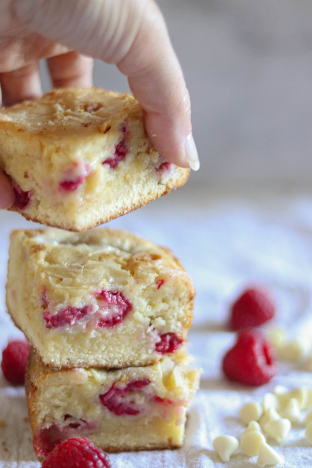 Stack of three blondies with raspberries.