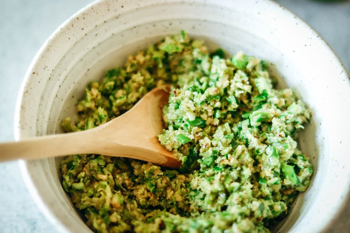 Garlic scape pesto in a white bowl.