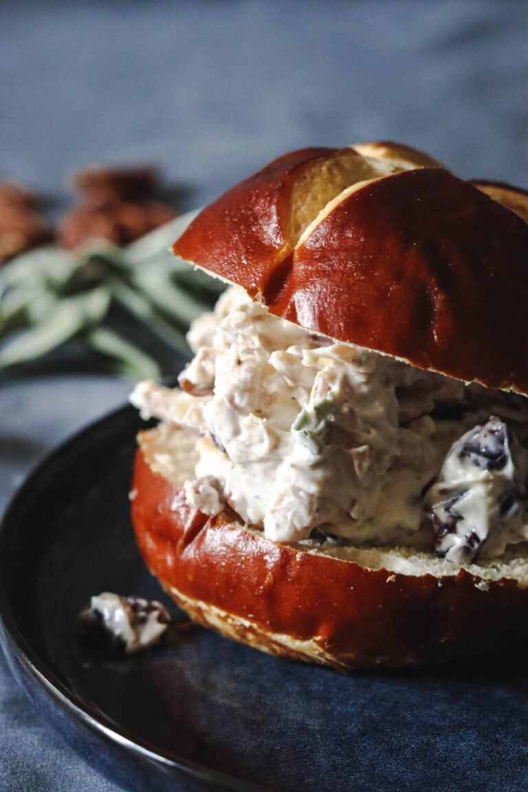 Turkey sandwich on a pretzel bun.