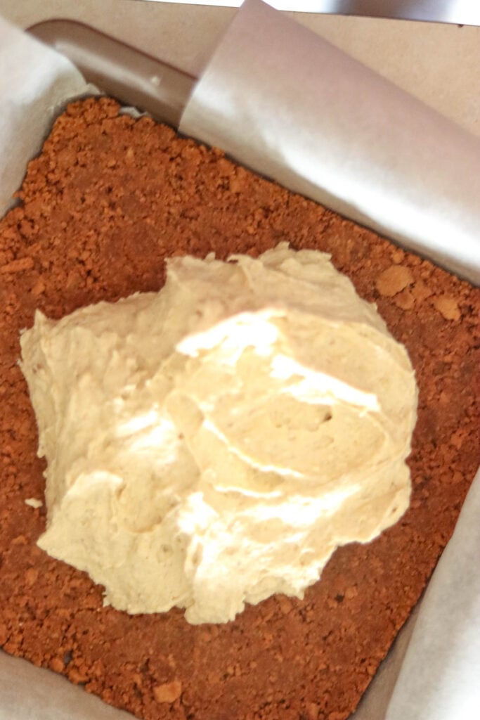 Spoon the cheesecake batter on top of the crust.