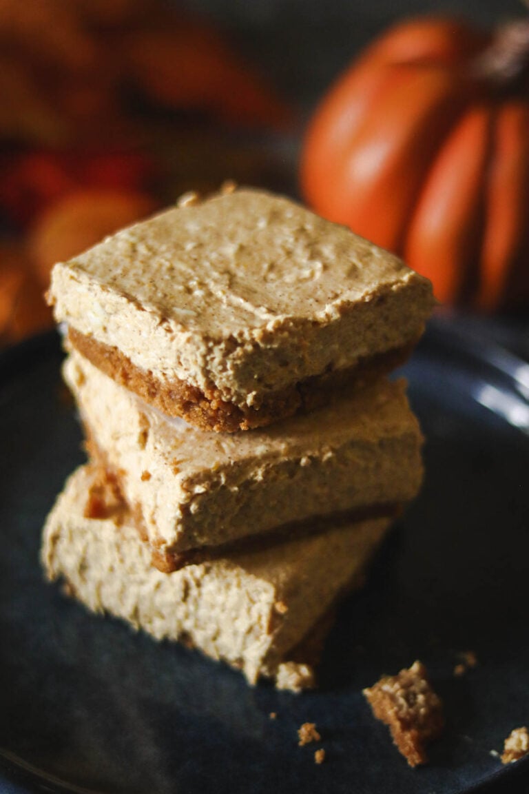 Stack of three no bake pumpkin cheesecake bars.