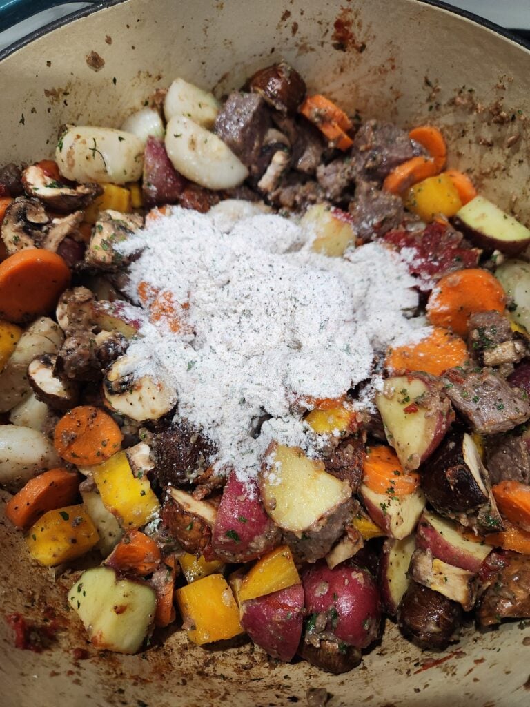 Photo showing the reserved flour being added to the stew.
