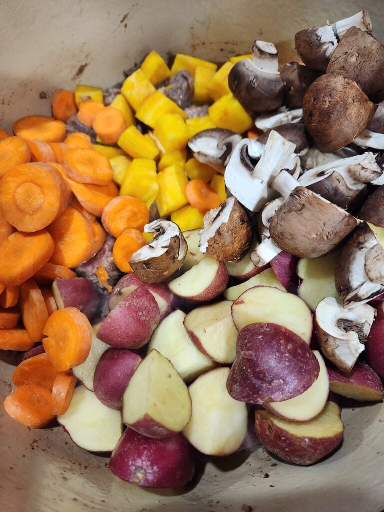 Photo of adding the vegetables after browning the meat.