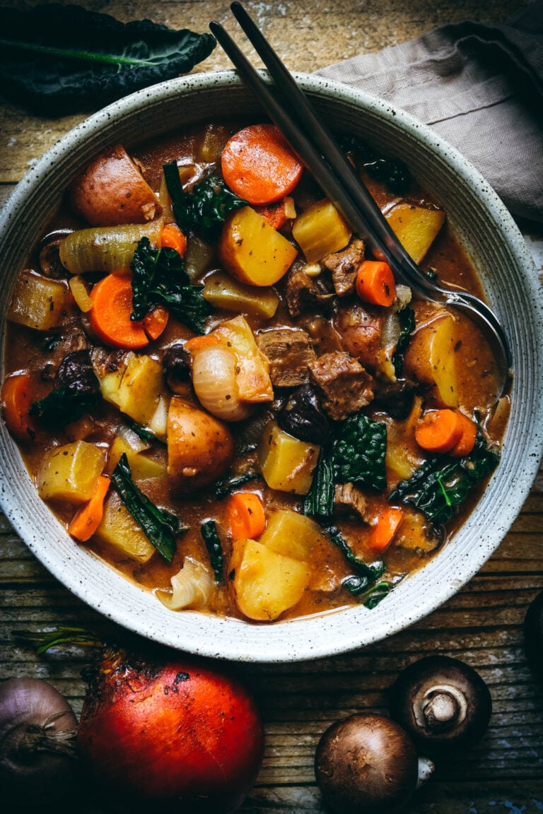 Beef stew with Autumn and Winter Vegetables with a metal spoon.